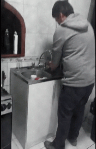 Man In Grey Hoodie Washing Dishes GIF