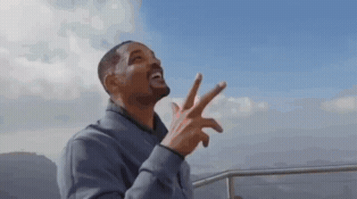 Man In Grey Jacket Giving Peace Sign GIF