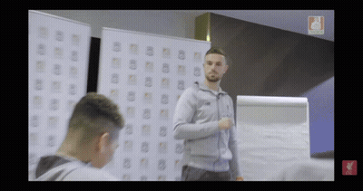 Man In Grey Jacket In Front Of Liverpool Whiteboard GIF