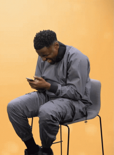 Man In Grey Jacket Looking At Phone GIF