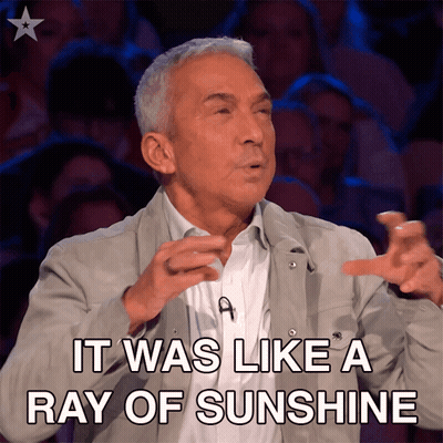 Man In Grey Jacket Saying Ray Of Sunshine GIF