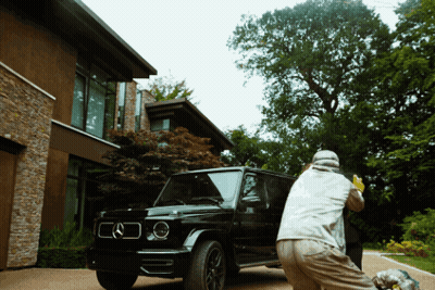 Man In Grey Jacket Standing In Front Of Glass Wall GIF