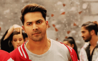 Man In Grey Shirt And Red Jacket In Front Of Group GIF