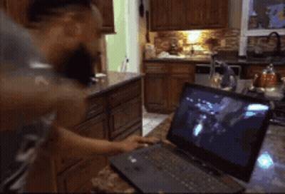 Man In Grey Shirt Cooking In Kitchen GIF