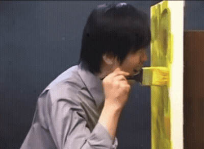 Man In Grey Shirt Holding Brush In Mouth GIF