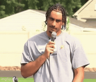 Man In Grey Shirt Holding Microphone GIF