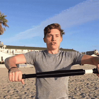 Man In Grey Shirt Holding Stick On Beach GIF