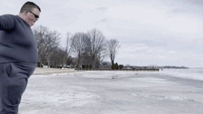 Man In Grey Shirt On Frozen Lake GIF