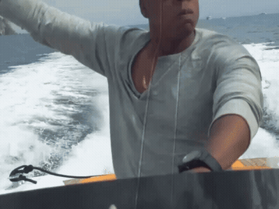 Man in Grey Shirt Riding Boat