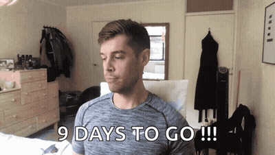 Man In Grey Shirt Says 9 Days To Go GIF