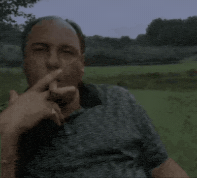 Man In Grey Shirt Smoking Cigarette In Field GIF