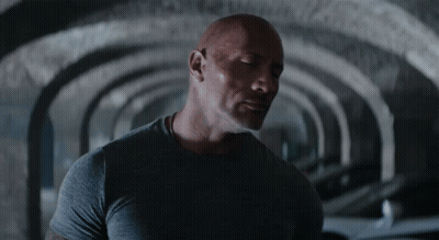 Man In Grey Shirt Standing In Tunnel GIF