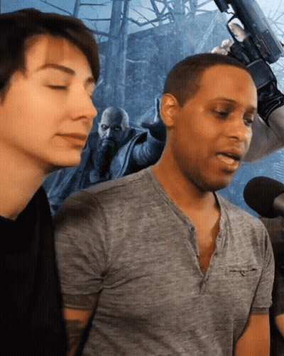 Man In Grey Shirt Talking Into Microphone GIF