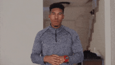 Man In Grey Sweater And Red Watch In Hallway GIF