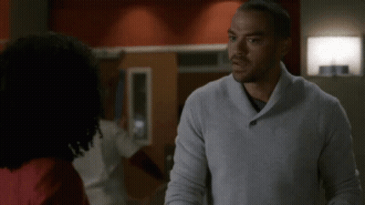 Man In Grey Sweater Looking At Another Man GIF