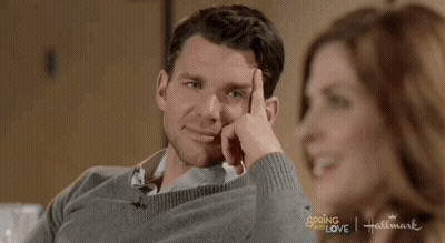 Man In Grey Sweater Next To Woman In Hallmark Spring Of Love Ad GIF