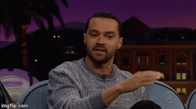 Man In Grey Sweater On Blue Couch Talking GIF