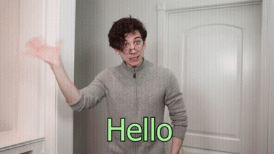Man In Grey Sweater Saying Hello GIF