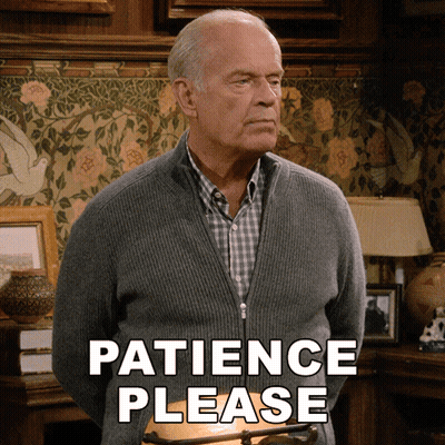 Man In Grey Sweater Saying Patience Please GIF