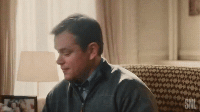 Man In Grey Sweater Sitting On Couch With SNL GIF