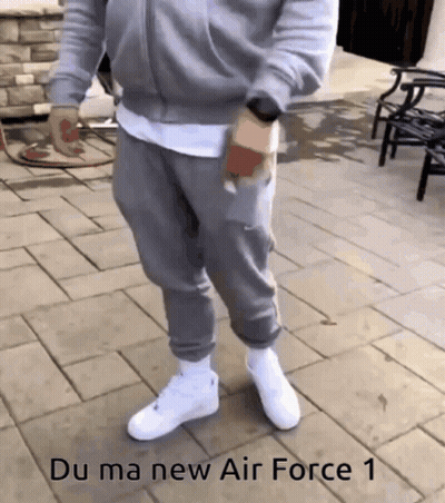 Man In Grey Sweatpants Standing On Brick Sidewalk Saying Du Ma New Air GIF