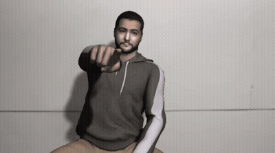 Man In Grey Sweatshirt Pointing At Camera GIF