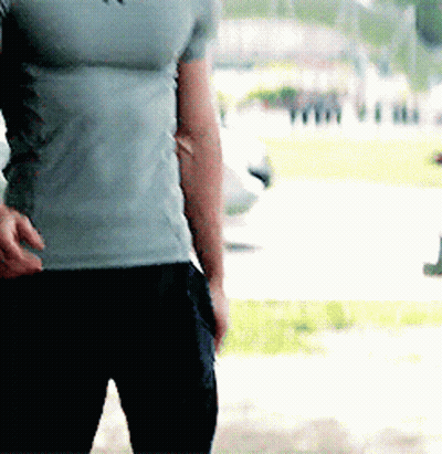 Man In Grey T-Shirt And Black Pants Standing In Park GIF