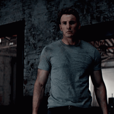 Man In Grey T-Shirt In Front Of Brick Wall GIF