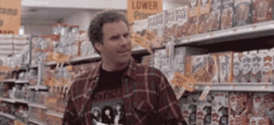 Man In Grocery Aisle Looking At Cereal Boxes GIF
