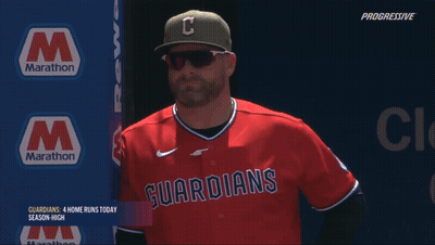 Man In Guardians Jersey In Front Of Marathon Sign GIF