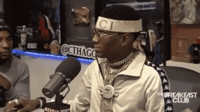 Man In Gucci Headband Sitting At Microphone GIF