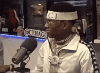 Man In Gucci Headband Talking Into Microphone GIF