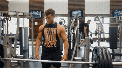 Man In Gym In Black Tank Top Saying Better Than Ever GIF