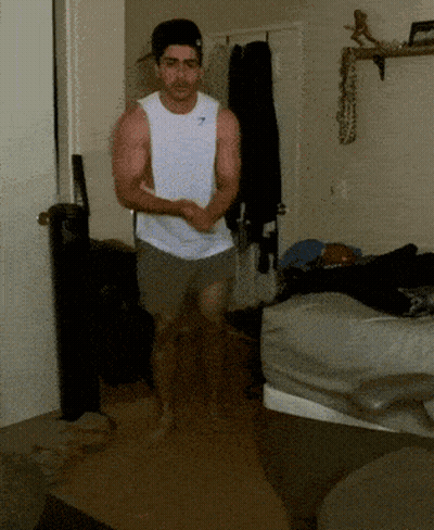 Man In Gymshark Tank Top Running In Room GIF