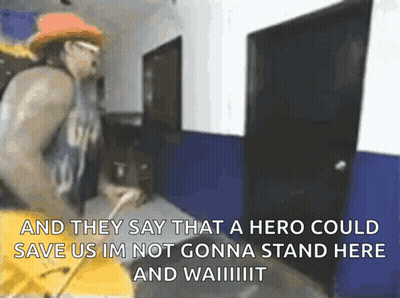 Man In Hallway With Sign Saying And They Say That A Hero Could Save Us GIF