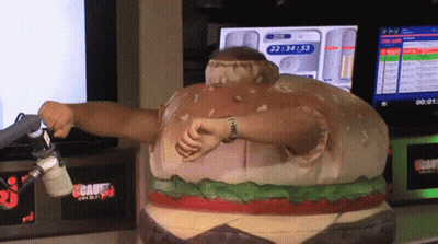 Man in Hamburger Costume in Front of Screen Showing 22:44:53