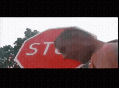 Man In Hard Hat And Glasses Next To Stop Sign Saying Stop Having Sex GIF