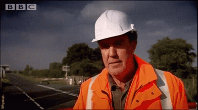 Man In Hard Hat And Orange Jacket On BBC Channel GIF