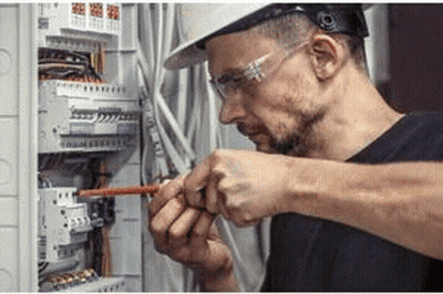 Man In Hard Hat And Safety Glasses Working On Electric Box GIF