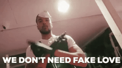 Man In Hard Hat Holding Gun Says We Don't Need Fake Love GIF