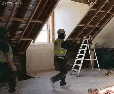Man In Hard Hat Holding Ladder In Attic GIF