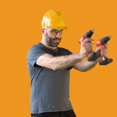 Man In Hard Hat Holding Two Hilti Tools GIF
