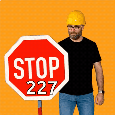 Man In Hard Hat Next To Stop Sign GIF