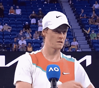 Man In Hat And Ao Shirt Talking Into Microphone GIF