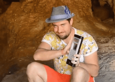 Man In Hat And Banana Shirt Holding Phone GIF