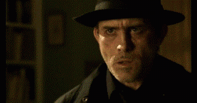 Man in Hat and Black Coat Making Funny Face
