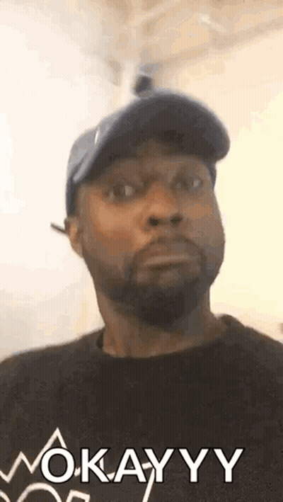 Man In Hat And Black Shirt Saying Okay GIF