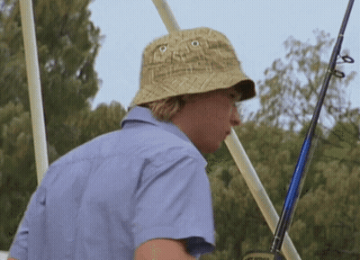 Man In Hat And Blue Shirt Holding Fishing Rod GIF