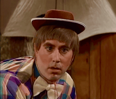 Man In Hat And Bow Tie Looking Camera GIF