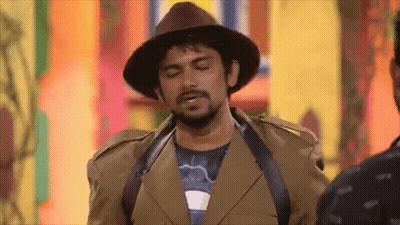 Man In Hat And Brown Jacket Standing Next To Another Man GIF